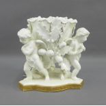 Moore white glazed porcelain cherub cache pot on a gilt edged base with embossed Greek Key frieze,