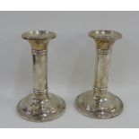 Edwardian pair of silver candlesticks with plain stems and circular foot rims, Birmingham 1904,