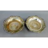 Pair of silver plated wine coasters with turned wooden bases, 20cm diameter, (2)