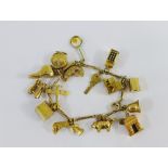 9 carat gold charm bracelet hung with a quantity of 9 carat gold charms to include a telephone