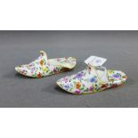 Pair of porcelain floral patterned slipper shoes with blue cross sword marks to base, 9.