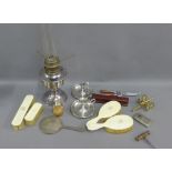 Carton of Epns wares to include an oil lamp base, candlesticks, etc., together with an early 20th