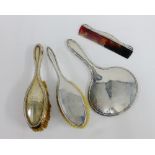 Various early 20th century silver backed dressing table sets to include a hand mirror, comb and