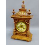 Mahogany cased mantle clock with finials and fluted top over a brass dial with enamel chapter ring