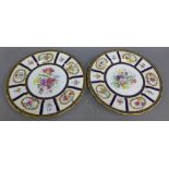 Pair of Paragon bone china cabinet plates with hand painted floral sprays and signed Holland, (2)