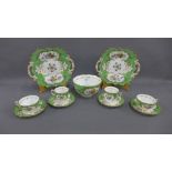 English porcelain teaset with green borders, gilt edge rims and hand painted floral sprays