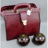 Set of four bowling balls in case