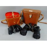 Two pairs of binoculars in leather cases, (2)