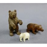 Early 20th century small carved elephant ivory figure and two wooden bear figures, tallest 6cm, (3)