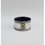 Russian white metal napkin ring with an inset diamond and yellow metal monogram, pseudo Faberge