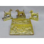 Two Airedale brass bookends, a Sealyham Terrier wall plaque and a brass hunting dog letter rack, (4)