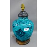 Isnic style turquoise blue glazed table lamp base with fish pattern on an ebonised wooden base (a/f)