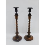 Pair of oak barley twist stems candlesticks with detachable bronze scones, 40cm high, (2)