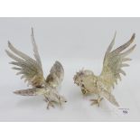 A pair of white metal table birds, 18cm high (2