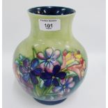 Moorcroft vase, tubeline decorated with Spring Flowers pattern to a blue and green ground with