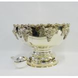 A large Epns punch bowl with fruit and vine pattern and on a circular pedestal base together with