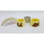 Two early 20th century ivory napkin rings, each with a yellow metal monogram together with a