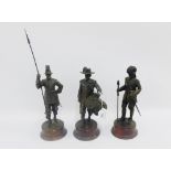 Three Peter Hicks faux bronze military figures on circular wooden plinth bases, 25cm high, (3)