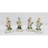 Set of four Capodimonte bisque pottery figures on circular gilt edged bases, 13cm high, with blue