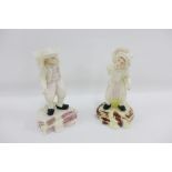 Pair of Belleek Male and Female Hawker spill back figures with black printed backstamps, 18cm