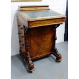 19th century walnut Davenport, with sloping top and inset skivver over four drawers with carved