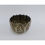 Eastern white metal bowl, chased with deity panels, 10cm wide