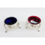 Pair of Victorian silver salts, one with blue glass liner the other with a red glass liner,