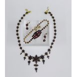 A suite of garnet and paste jewellery, set in gilt metal, to include a necklace, earrings and
