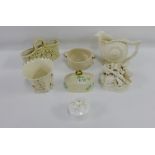 Collection of Belleek porcelains to include a shell shaped jug, a floral encrusted basket, a