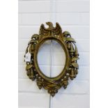 Heavy gilt metal oval frame, the top with an Eagle, 40cm long