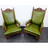 A pair of Edwardian oak framed open armchairs, with carved top rail and upholstered back, arms and