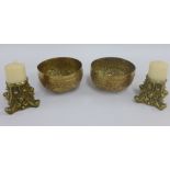 Two Indian brass bowls, together with a pair of brass candlesticks, (4)