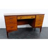 Retro teak desk with central long drawer flanked by three short drawers to each pedestal, on