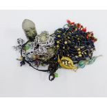 A collection of costume jewellery to include beads, necklaces and brooches, etc (a lot)