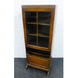 Early 20th century oak bookcase with glazed door above a magazine rack, 128 x 52cm