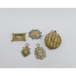 A collection of three early 20th century silver fob medallions, white metal brooch and locket (5)