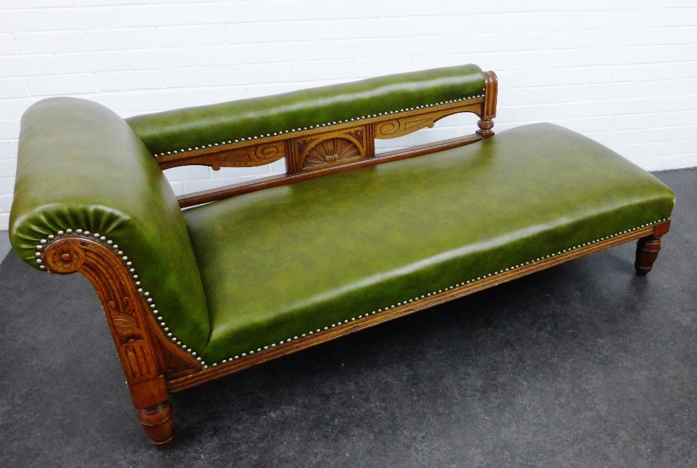 Edwardian oak framed chaise longue with carved upright with fan detail and green upholstered seat