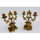 Pair of painted brass twin branch candlesticks, 27cm high, (2)