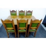 Early 20th century oak dining table and set of six chairs with green vinyl backs and seats, (7) 76 x