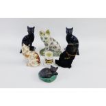 Pair of black glazed Jackfield style cats, a sponge ware cat, a W.H. Goss, Manx cat jug and a toy