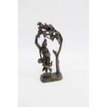 Bronze Deity figure modelled standing beneath a tree on a plinth base, 27.5cm high