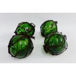 Four green glass fishing floats, (4)