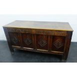 Dark oak coffer, with plain hinged lift up top and with four carved panels and inscribed date 1687