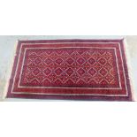 Afghan rug, the red field rug with diamond lozenge motifs, 205 x 100cm