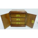 Miniature mahogany cabinet, the rectangular top with moulded edge over two panelled doors opening to