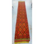 Afghan Meshwani runner, the red field with diamond lozenge motifs, 356 x 66cm