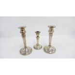 Pair of Edwardian silver candlesticks, Birmingham 1909, 18cm high together with another smaller (3)