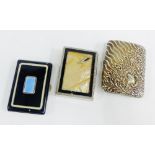 Three cigarette cases to include a black enamel case with blue guilloche panel, etc (3)