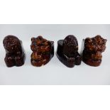 Two pairs of Victorian treacle brown glazed window stop / jambs, modelled as lions 11cm high, (4)