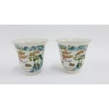 Pair of Chinese porcelain wine cups of bell form, finely painted with pagoda and landscape scenes,